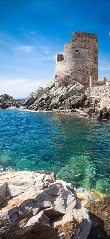 Seaside ancient stone tower stands on the rock phone wallpaper