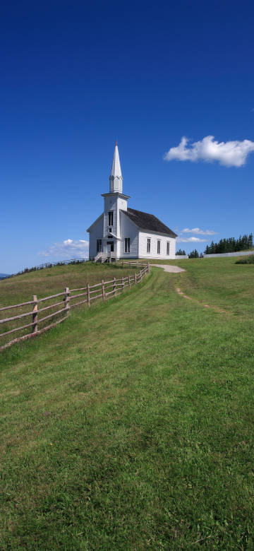 White country church on an open meadow phone wallpaer