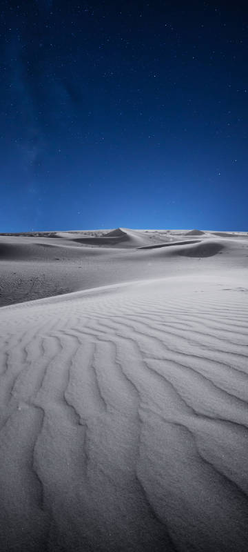 Deep blue night sky under the desert phone wallpaper