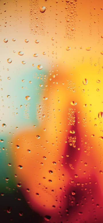 Water Drops On Orange Glass 4K Phone Wallpaper