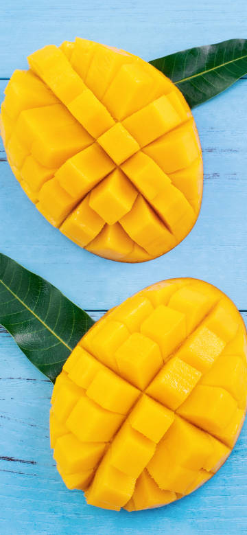 Two mangoes cut into a grid 4k phone wallpaper