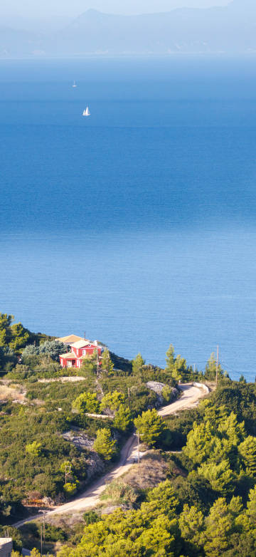 Blue sea with a few sailboats on the sea 4k phone wallpaper
