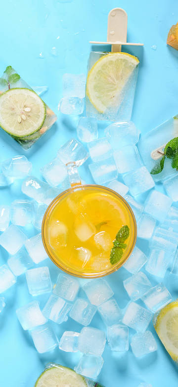 A glass of orange juice on ice phone wallpaper