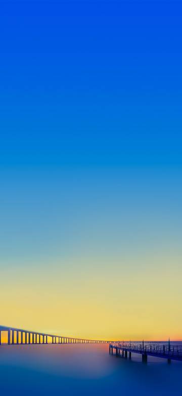 Bridge under blue and yellow gradient sky