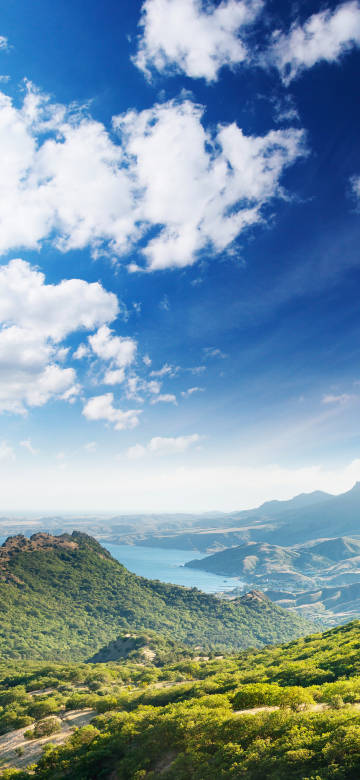 Peaceful Lake Surrounded by Lush Hills 4K Phone Wallpaper