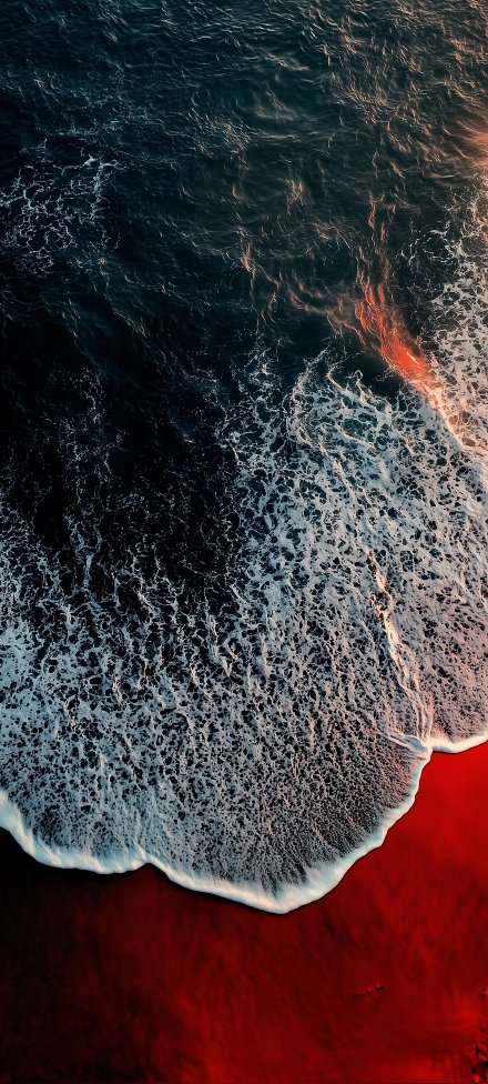 Ocean Waves Crashing on Red Sand 4K Wallpaper