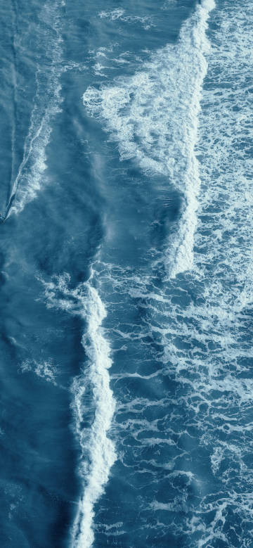 Aerial view of white waves on the sea wallpaper