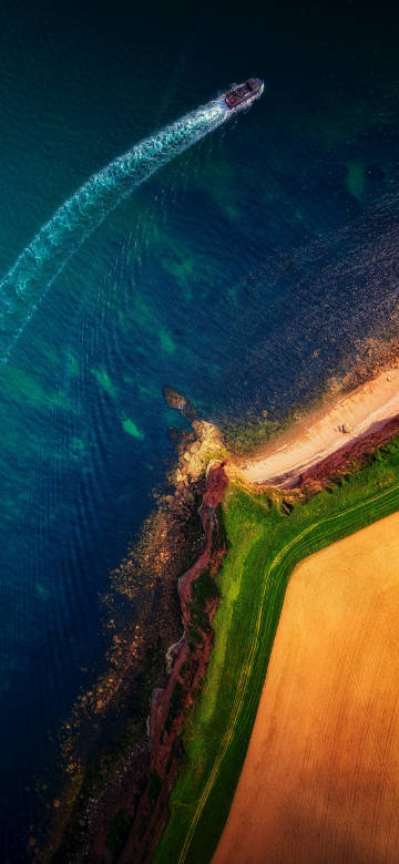 Aerial View of Boat on Turquoise Water 4K Wallpaper