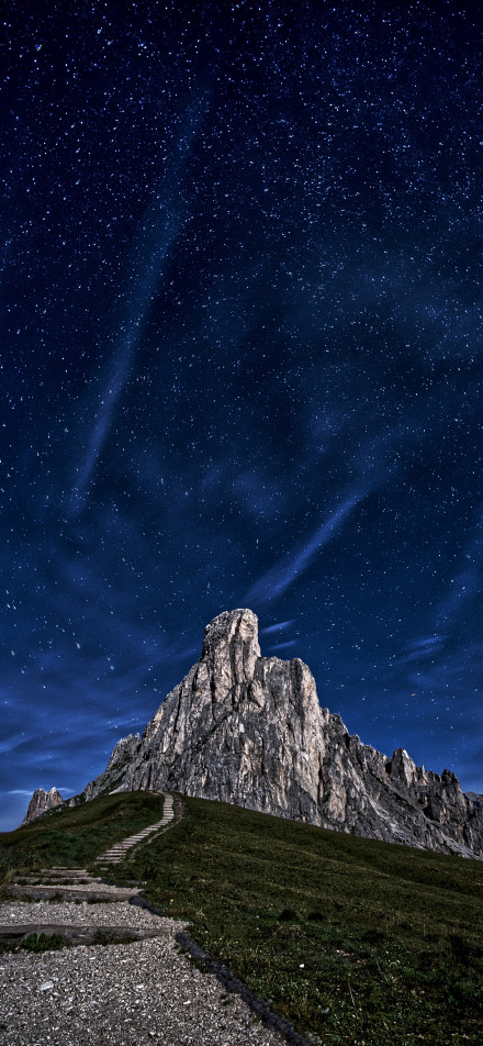 Soaring peaks under a blue starry sky phone wallpaper