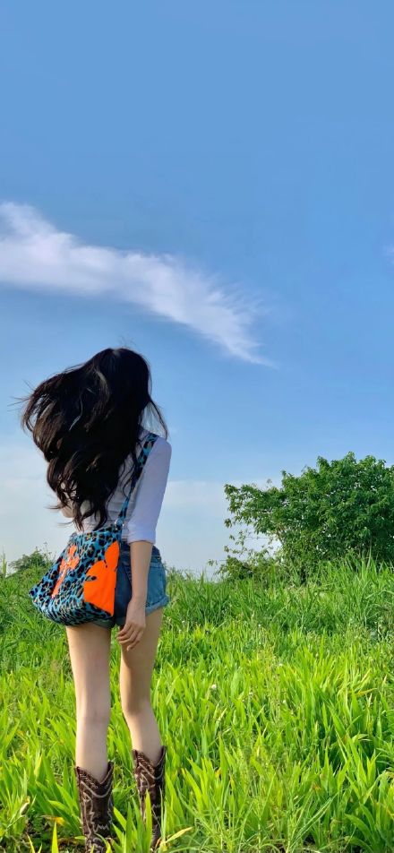 Girl Back View Standing In Green Field Blue Sky Wallpaper
