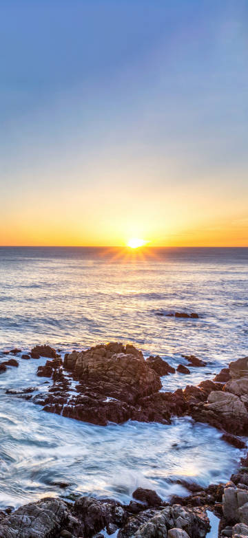 Peaceful Ocean Sunset with Rocks 4K Phone Wallpaper