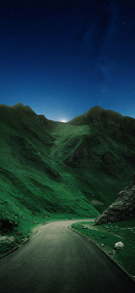 Tranquil night view of a mountain highway phone wallpaper