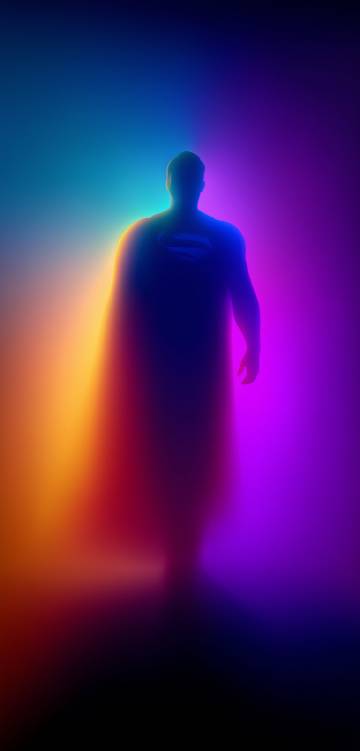 Superman Standing in a Colorful Glow HD Wallpaper