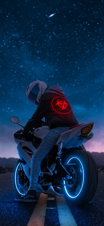 Motorcyclist under the night sky