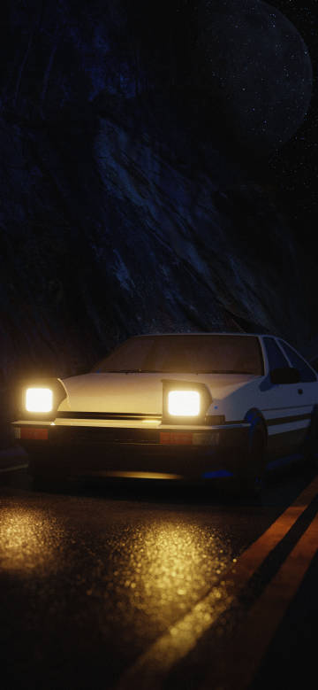 Car parked on mountain road with two headlights on