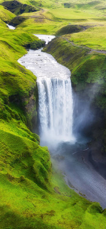 Magnificent waterfall scenery surrounded by grass