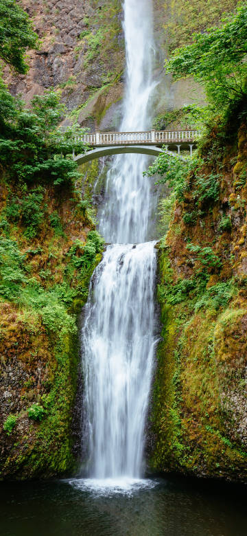 Arch bridge over waterfall