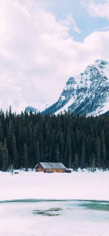 Tranquil chalet under snowy winter mountains