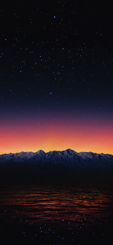 Snow - capped Mountains Reflecting in Water under the Stars