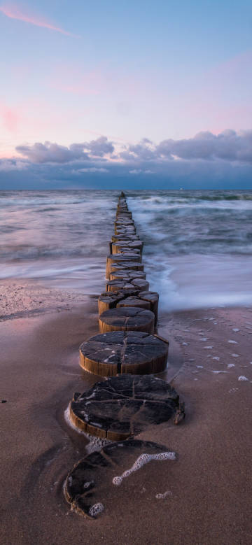 Wooden pile path by the seaside under the twilight