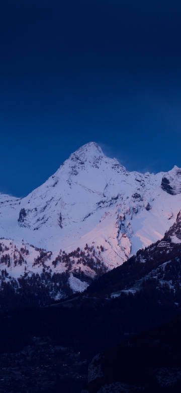 Pink-hued Snowy Peak under the Blue Sky