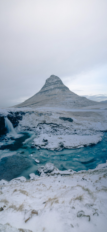 Snow - covered Steep Mountain and Blue Stream