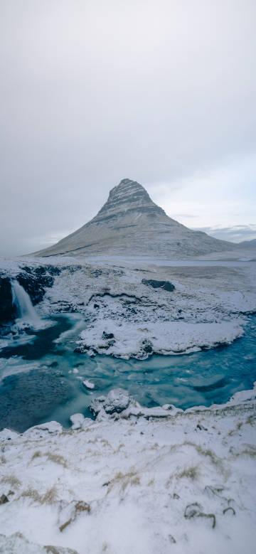 Snow - covered Steep Mountain and Blue Stream