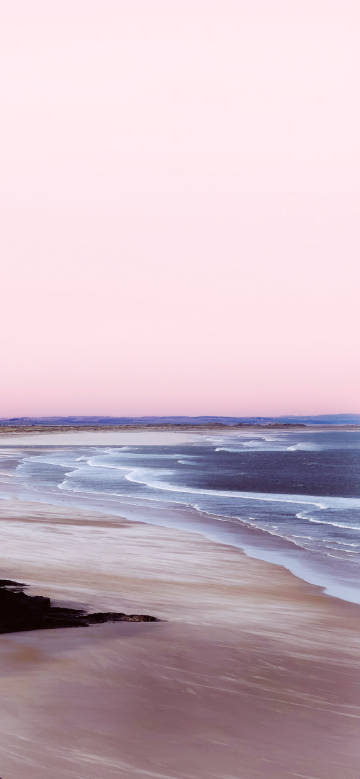 Seaside under a pink sky