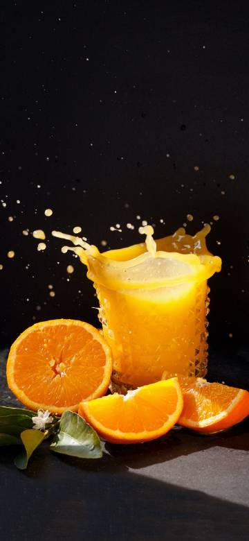 Orange Juice Splashing and Fresh Oranges
