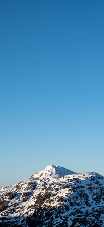 Snowy peaks under a pure blue sky