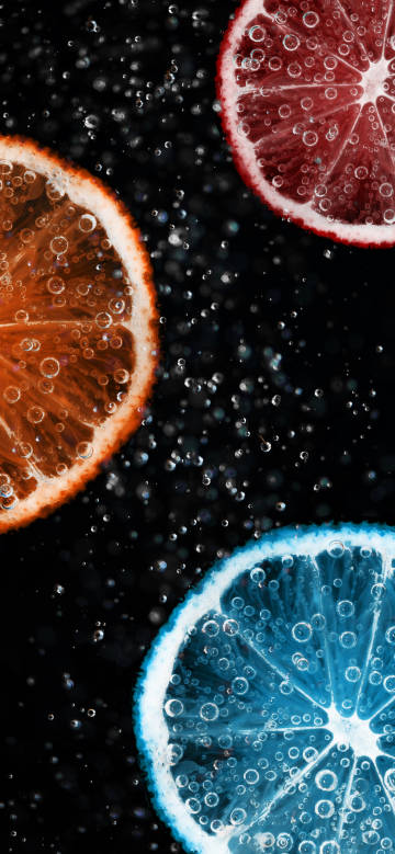 Fruit slices with bubbles on a black background