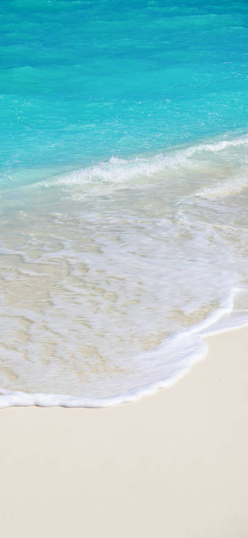 Encounter of clear blue sea water and white waves