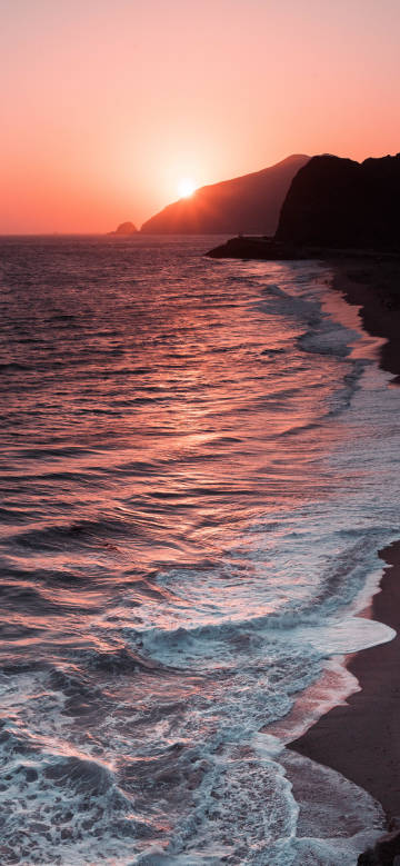 Charming seaside sunset in the orange-red afterglow