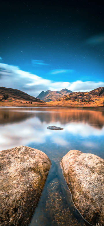 Serene mountain lake under the starry sky