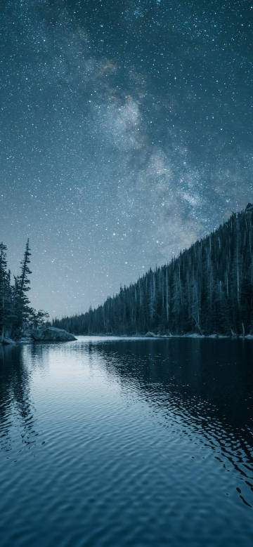 Serene lakeside night under the starry sky