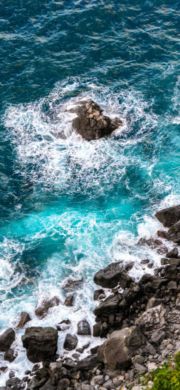 Overlooking the sea water hitting the rocks