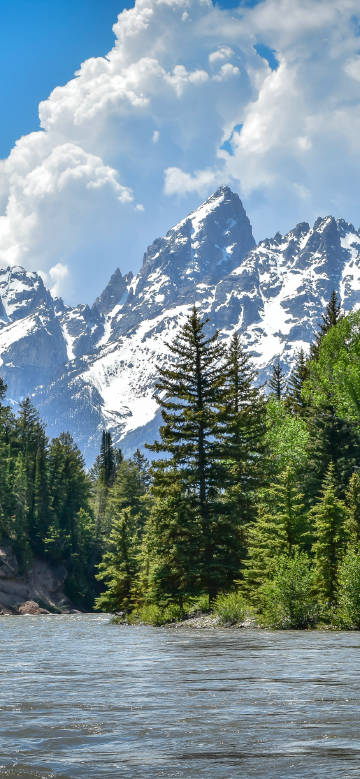 Blue sky, white clouds, snow mountain lakeside
