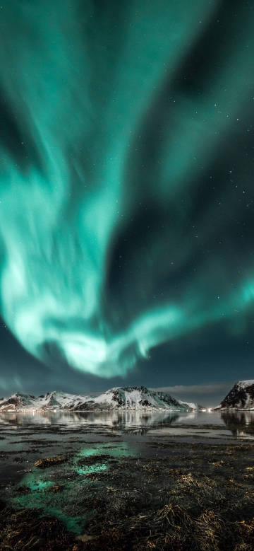 Snow-capped mountains under the Aurora