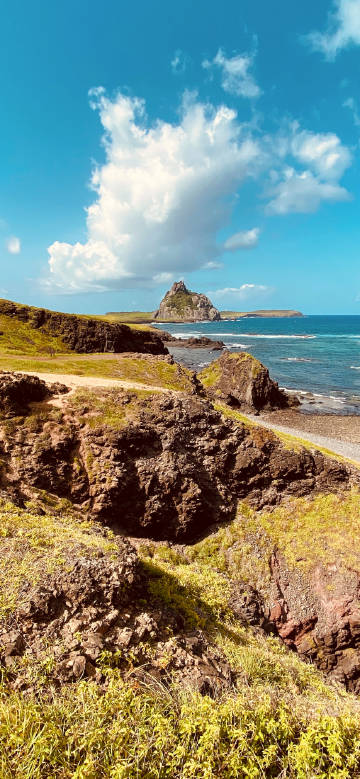 The rugged coast between blue sea and sky