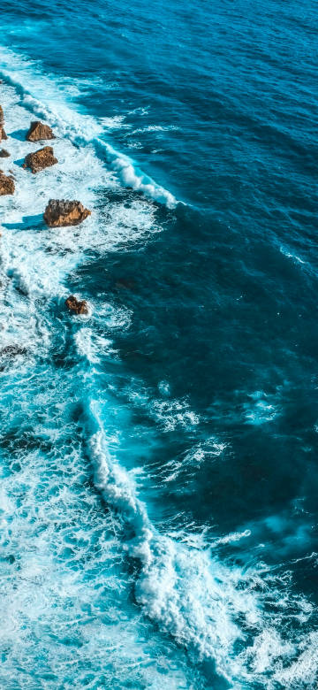 Shadow of waves on reefs in the blue sea