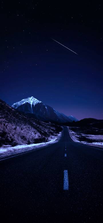 Snowy mountains and roads under the starry sky