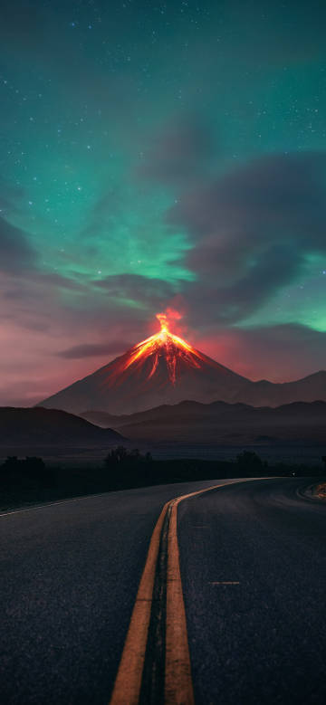 View of a volcano erupting at night