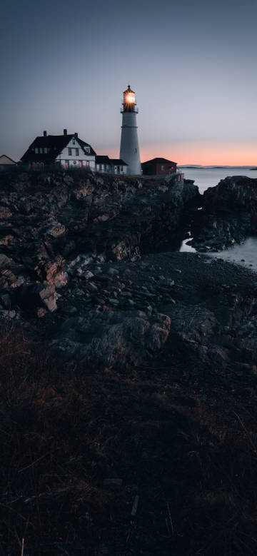 A lighthouse on a rocky shore.