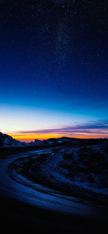 Mountain road under the dark blue night sky
