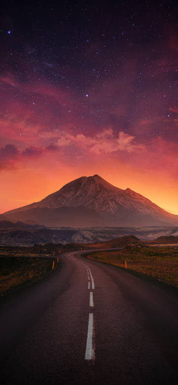 Mountain peaks under an orange starry sky