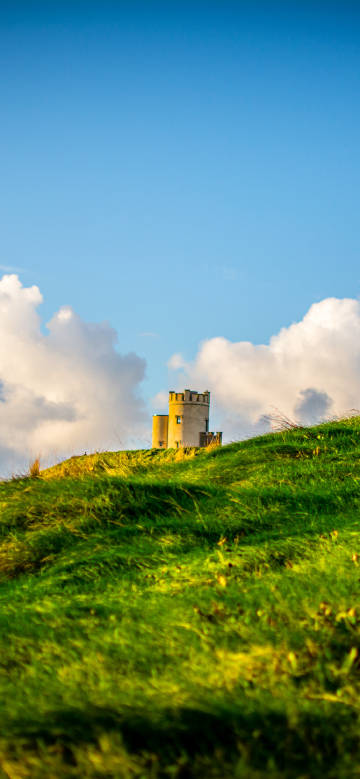 Tower on hill in sunlight