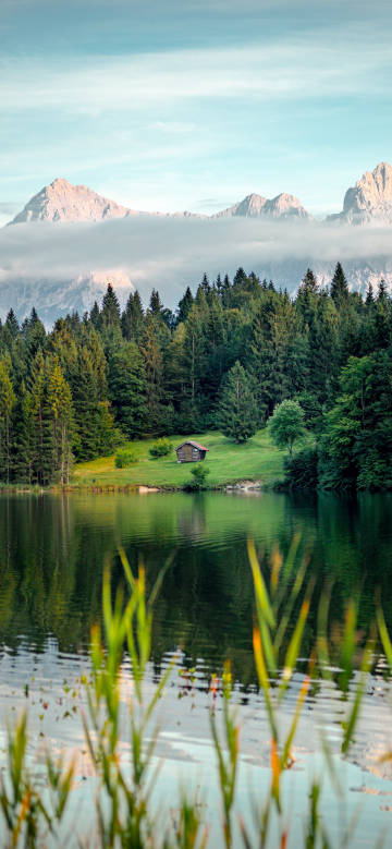 Beautiful landscape of mountains and water under clouds