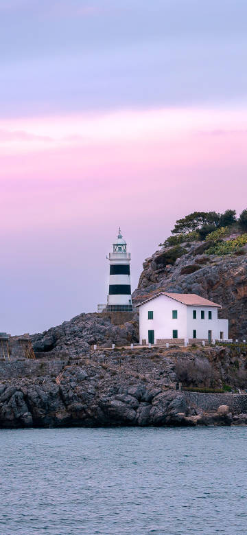 Lighthouse and cottage by the coast