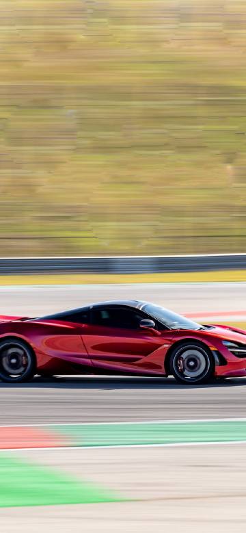 Red mcLaren racing on the track