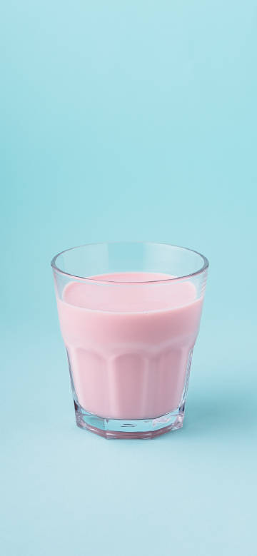 Pink drink against light blue background